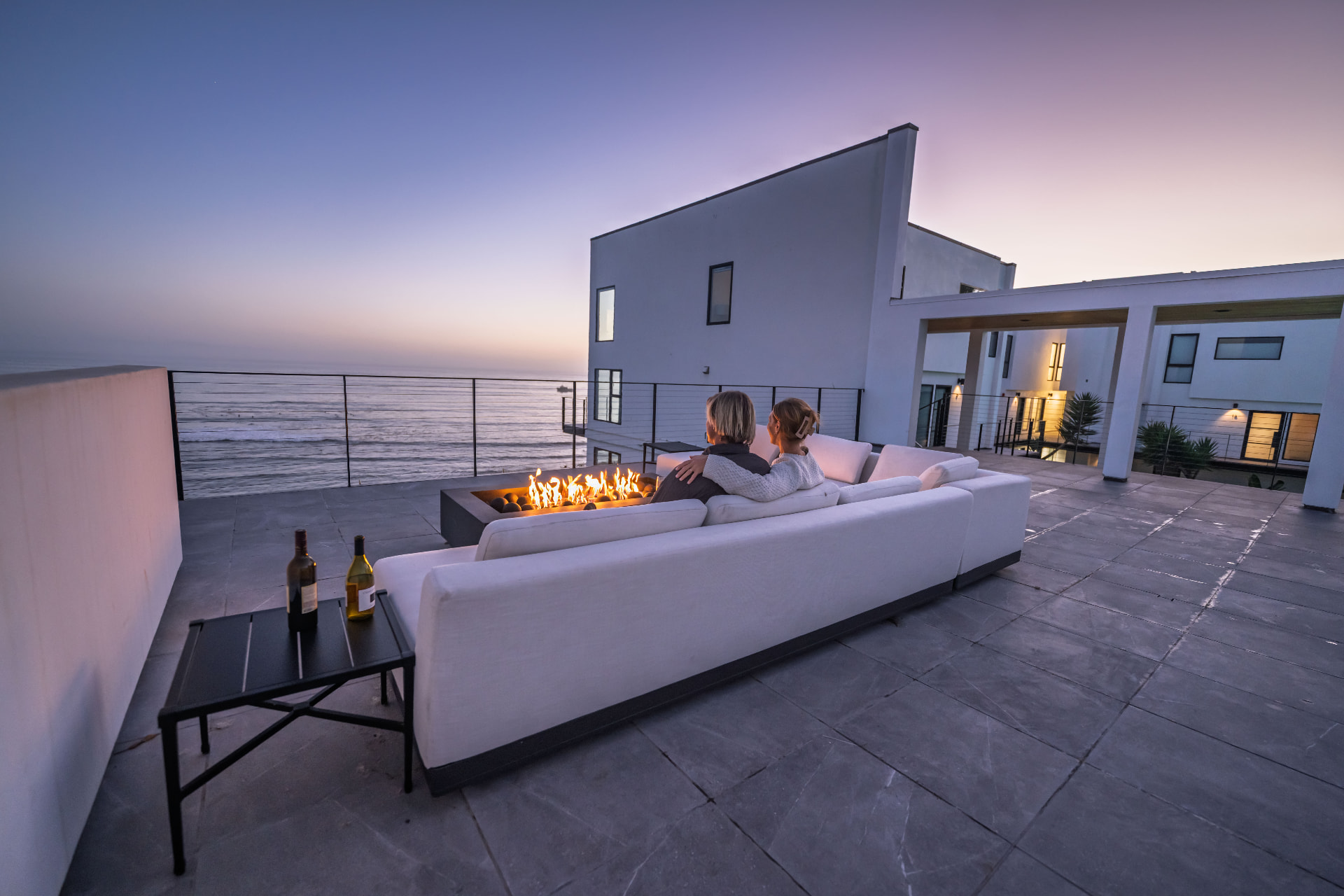 Couple beside the shared firepit at Grand Avenue